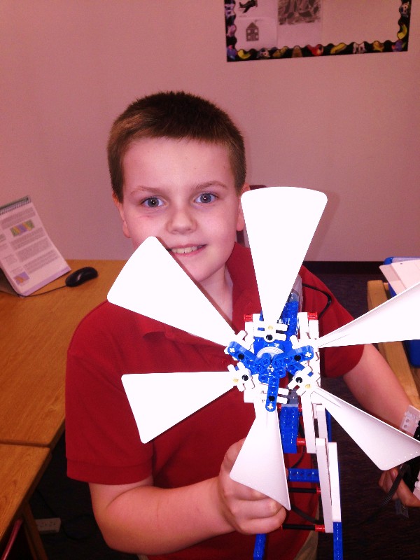 In May, a student at Anchorage Christian School poses with his wind energy LEGO project. The chapter awarded a $1,000 grant to the school to purchase LEGO Mindstorms kits.